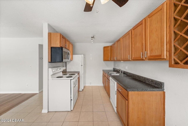 kitchen featuring a textured ceiling, sink, white appliances, ceiling fan, and light hardwood / wood-style flooring