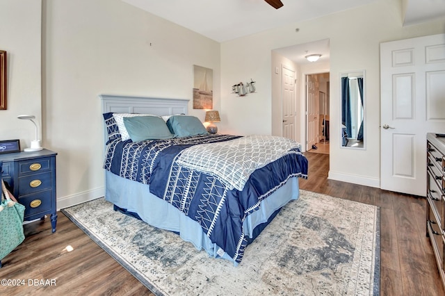 bedroom featuring ceiling fan and dark hardwood / wood-style floors