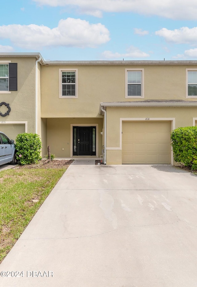 multi unit property featuring a garage