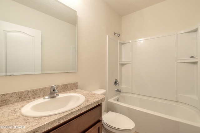 full bathroom with vanity, a textured ceiling, toilet, and bathing tub / shower combination