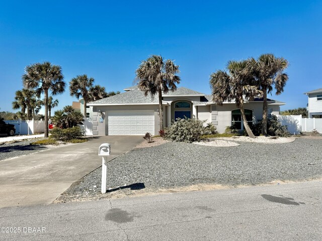 1811 N Central Ave, Flagler Beach, FL 32136 - ranch-style home featuring concrete driveway, an attached garage, fence, and stucco siding