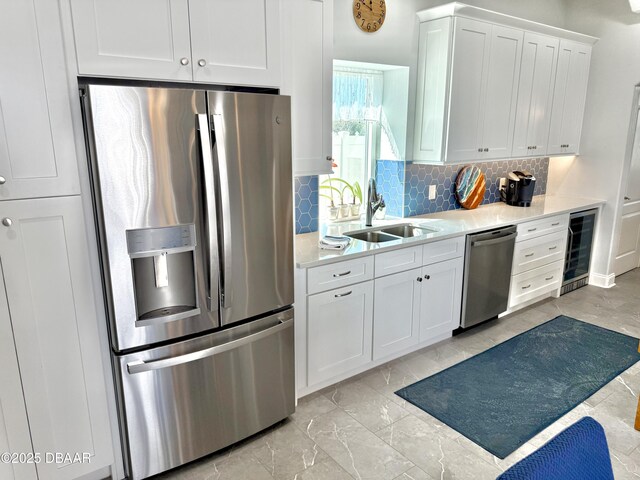 1811 N Central Ave, Flagler Beach, FL 32136 - kitchen with backsplash, a sink, light countertops, wine cooler, and stainless steel appliances