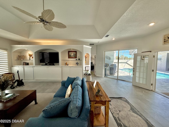 1811 N Central Ave, Flagler Beach, FL 32136 - living room with ceiling fan, a textured ceiling, visible vents, a tray ceiling, and recessed lighting