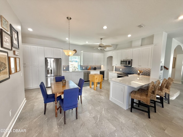 1811 N Central Ave, Flagler Beach, FL 32136 - dining area with arched walkways, a ceiling fan, recessed lighting, and visible vents