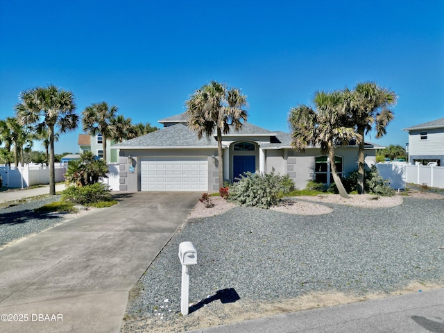 1811 N Central Ave, Flagler Beach, FL 32136 - view of front of house featuring fence, a shingled roof, a garage, stucco siding, and concrete driveway
