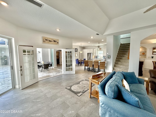 1811 N Central Ave, Flagler Beach, FL 32136 - living area featuring arched walkways, french doors, recessed lighting, visible vents, and stairway