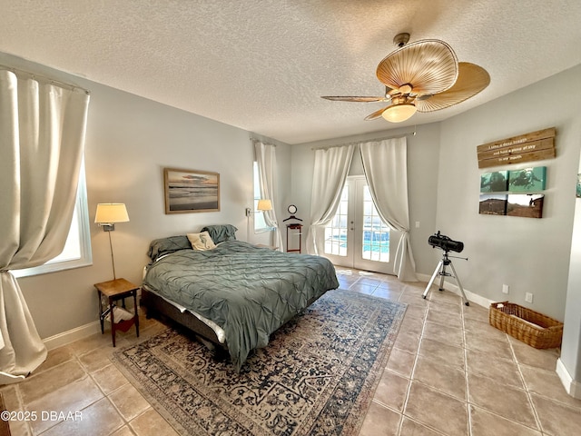 1811 N Central Ave, Flagler Beach, FL 32136 - bedroom featuring access to outside, light tile patterned flooring, and a textured ceiling
