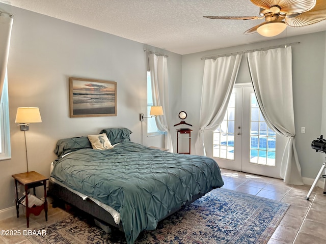 1811 N Central Ave, Flagler Beach, FL 32136 - tiled bedroom with baseboards, a textured ceiling, french doors, and access to exterior