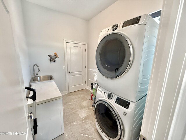 1811 N Central Ave, Flagler Beach, FL 32136 - washroom featuring stacked washing maching and dryer, baseboards, laundry area, and a sink