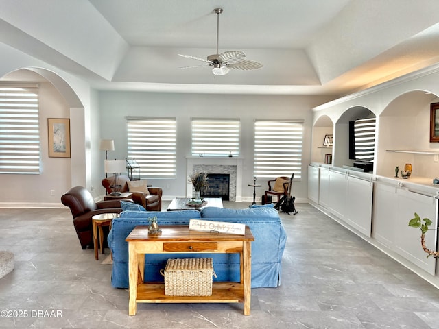 1811 N Central Ave, Flagler Beach, FL 32136 - living room with a raised ceiling, ceiling fan, a wealth of natural light, and a fireplace