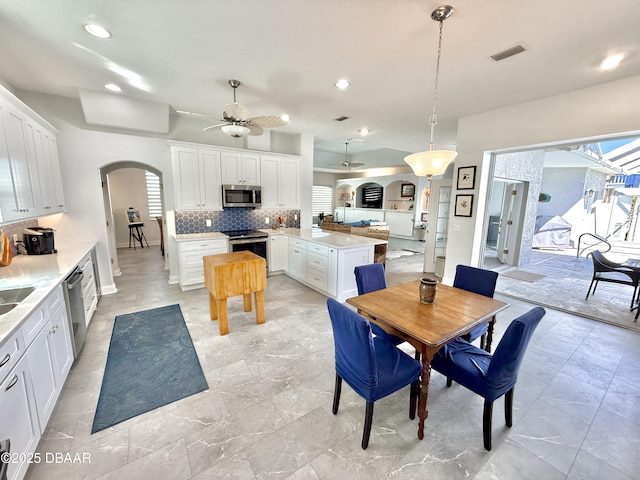 1811 N Central Ave, Flagler Beach, FL 32136 - dining area featuring visible vents, arched walkways, ceiling fan, and recessed lighting