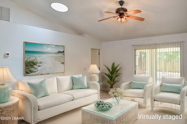 living room featuring hardwood / wood-style floors, ceiling fan, and vaulted ceiling