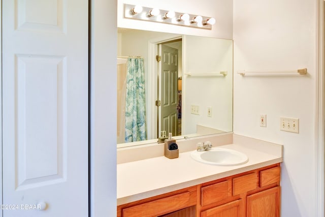 bathroom with walk in shower and vanity