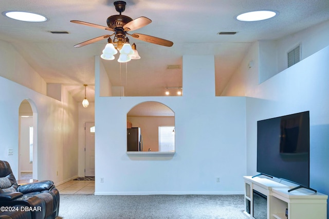 living room with high vaulted ceiling, light colored carpet, and ceiling fan