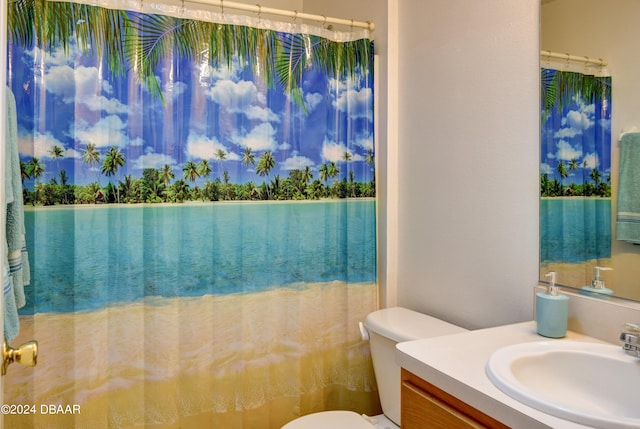 bathroom with walk in shower, vanity, and toilet