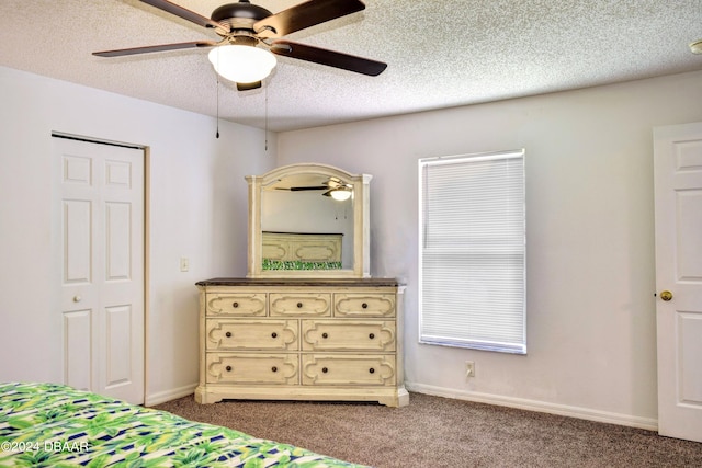 carpeted bedroom with a textured ceiling and ceiling fan