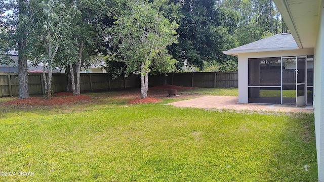 view of yard featuring a patio and a sunroom