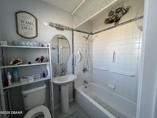 full bathroom featuring bathtub / shower combination, toilet, a sink, and a textured ceiling