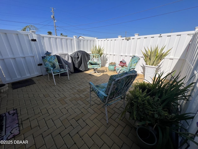 view of patio featuring a fenced backyard and grilling area