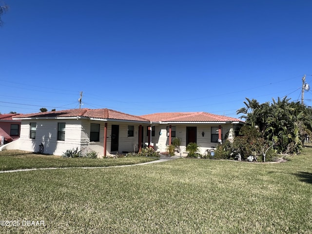 view of front of home with a tile roof and a front yard