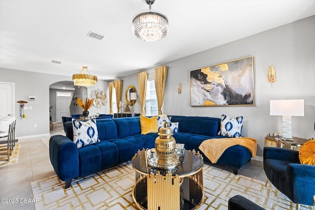 tiled living room featuring a chandelier