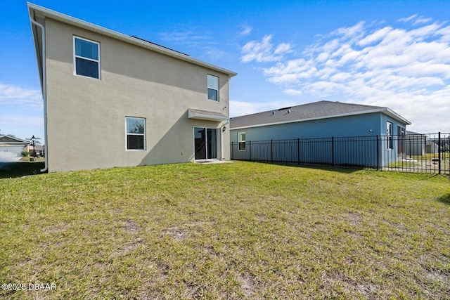 back of property featuring a lawn