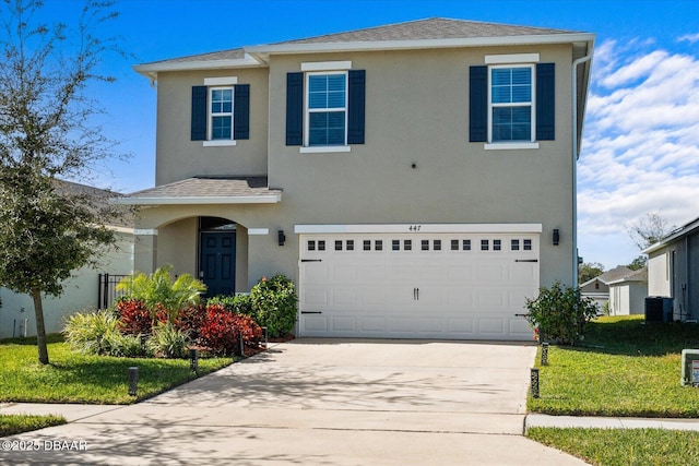 view of front of property featuring a garage, a front lawn, and central air condition unit