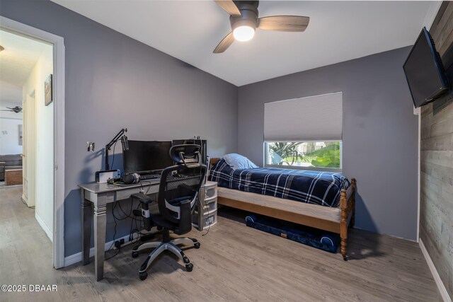 1052 Tompkins Dr, Port Orange, FL 32129 - bedroom featuring wood finished floors, an office area, and a ceiling fan