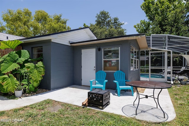 1052 Tompkins Dr, Port Orange, FL 32129 - rear view of property with concrete block siding, a patio area, an outdoor pool, and a lanai