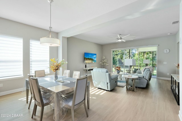 dining space with ceiling fan and light hardwood / wood-style floors