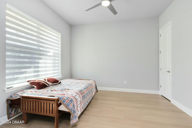 bedroom with ceiling fan and light wood-type flooring