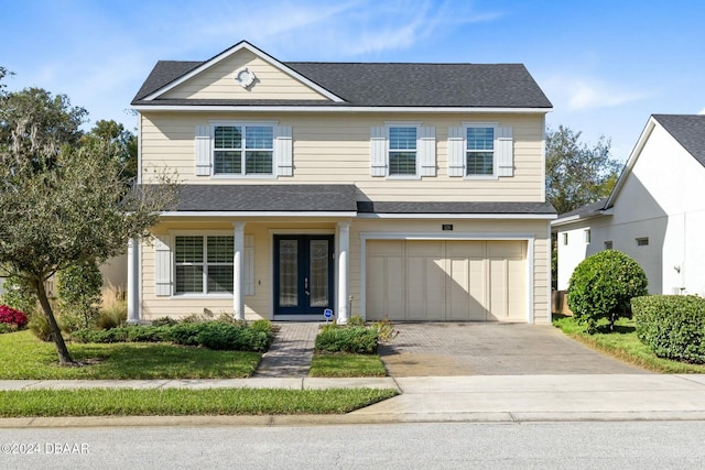 view of front property featuring french doors and a garage