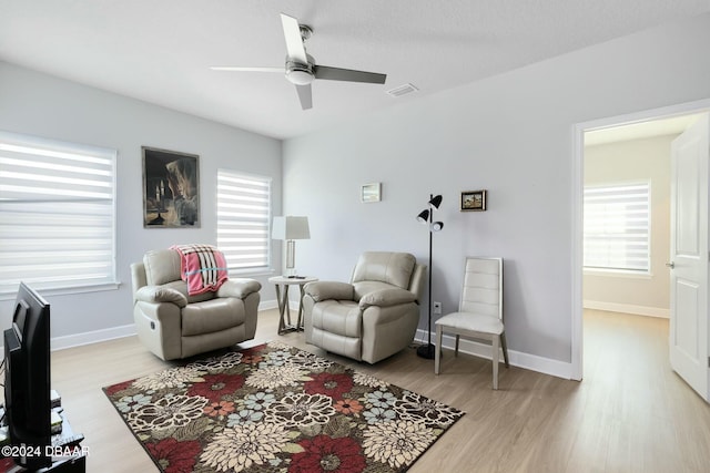 living area featuring ceiling fan and light wood-type flooring