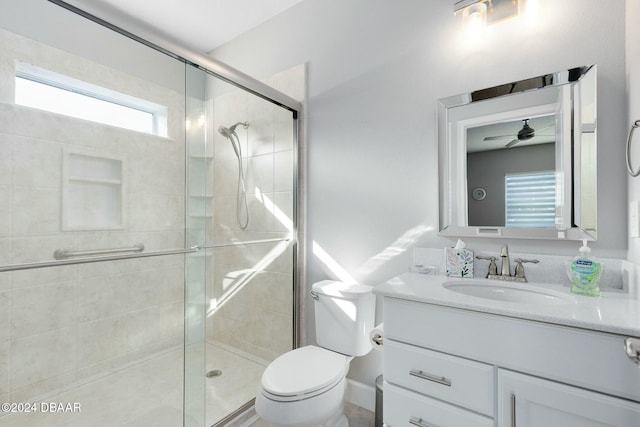 bathroom with vanity, toilet, walk in shower, and ceiling fan