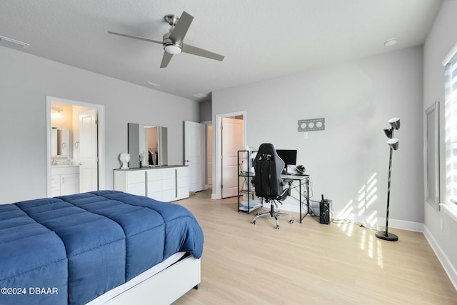 bedroom with light hardwood / wood-style floors, ceiling fan, and ensuite bathroom