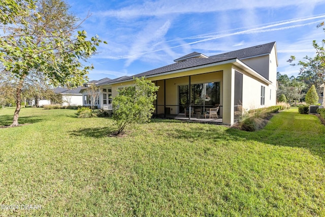 rear view of property featuring a lawn