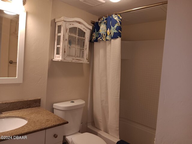 full bathroom with toilet, vanity, and shower / bath combination with curtain