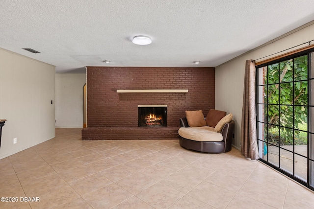 950 Pineapple Rd, South Daytona, FL 32119 - living area featuring light tile patterned floors, a textured ceiling, and a brick fireplace