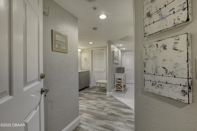 1 John Anderson Dr Unit 103, Ormond Beach, FL 32176 - hallway with light wood-type flooring, recessed lighting, and a textured wall