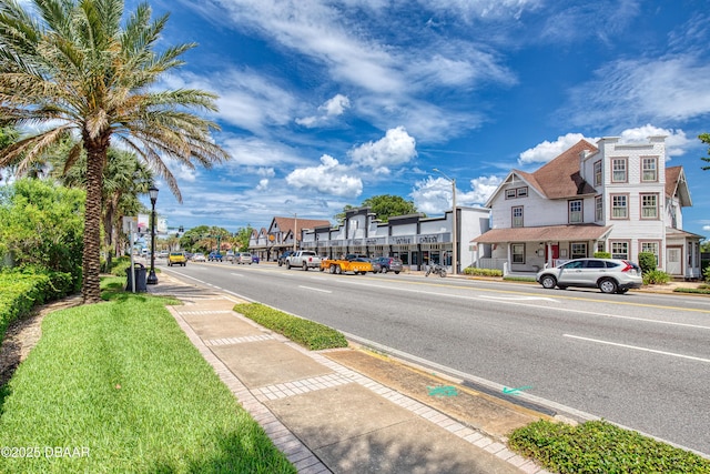 1 John Anderson Dr Unit 103, Ormond Beach, FL 32176 - view of asphalt road featuring street lighting, sidewalks, and curbs