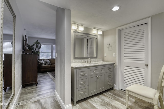 1 John Anderson Dr Unit 103, Ormond Beach, FL 32176 - bathroom featuring wood finished floors and vanity