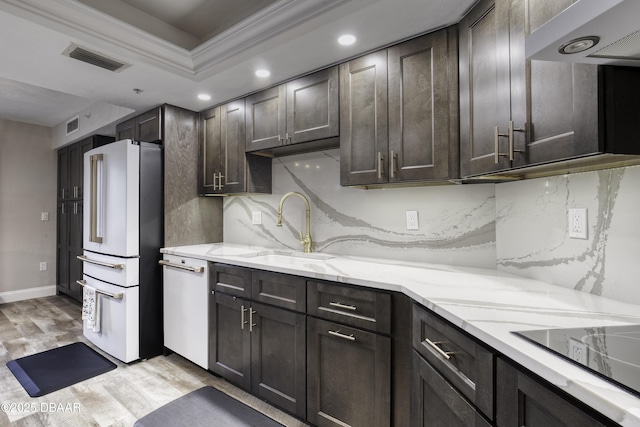 1 John Anderson Dr Unit 103, Ormond Beach, FL 32176 - kitchen with white appliances, range hood, dark brown cabinets, light wood-style flooring, and recessed lighting