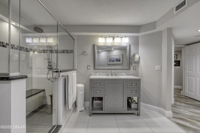 1 John Anderson Dr Unit 103, Ormond Beach, FL 32176 - full bathroom featuring vanity, a stall shower, and tile patterned floors