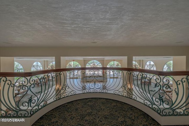 1 John Anderson Dr Unit 103, Ormond Beach, FL 32176 - hallway featuring a textured ceiling and plenty of natural light