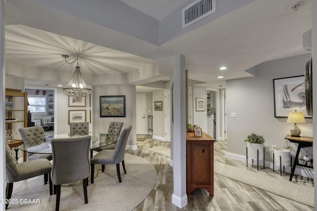 1 John Anderson Dr Unit 103, Ormond Beach, FL 32176 - dining room featuring wood finished floors, a chandelier, and recessed lighting