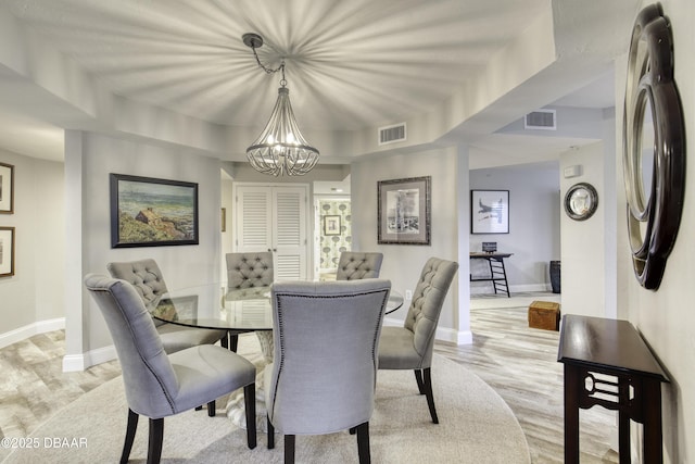 1 John Anderson Dr Unit 103, Ormond Beach, FL 32176 - dining room featuring a chandelier and light wood-type flooring