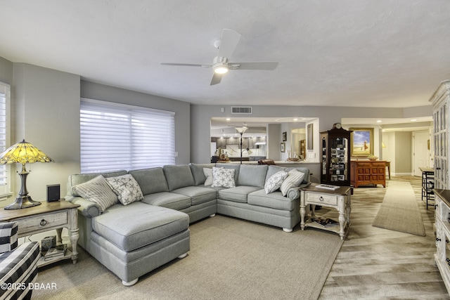 1 John Anderson Dr Unit 103, Ormond Beach, FL 32176 - living room featuring a ceiling fan and light wood-style floors