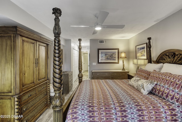 1 John Anderson Dr Unit 103, Ormond Beach, FL 32176 - bedroom featuring light wood-style floors, a ceiling fan, and connected bathroom