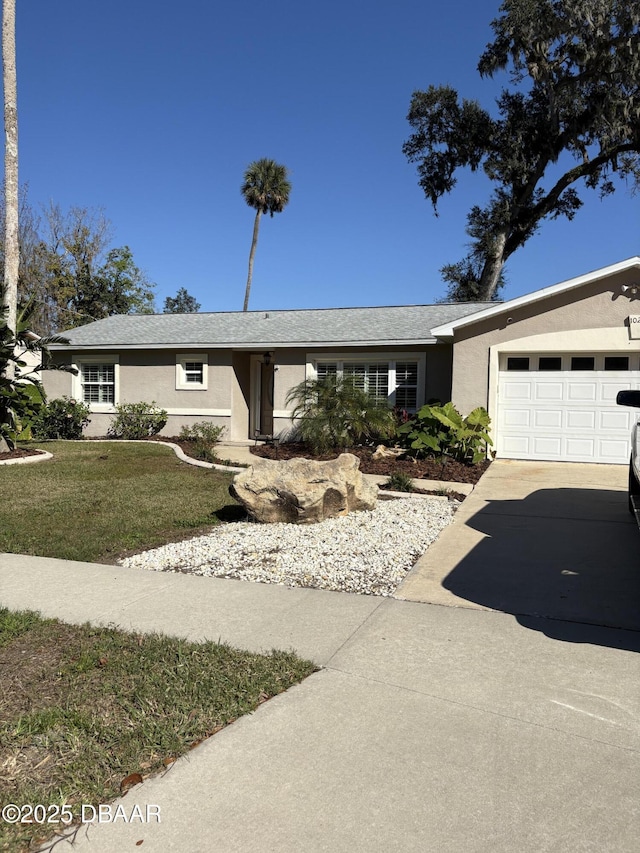 ranch-style home with a garage and a front yard