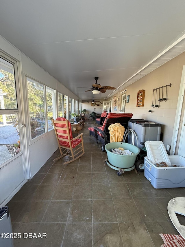 sunroom / solarium featuring a wealth of natural light and ceiling fan